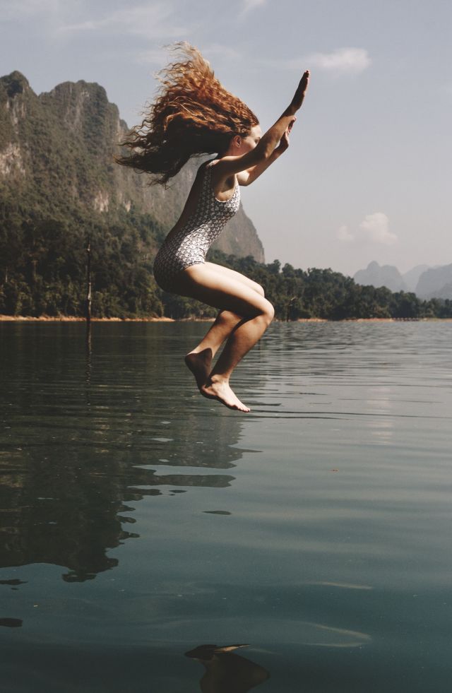 Woman jumping into the water